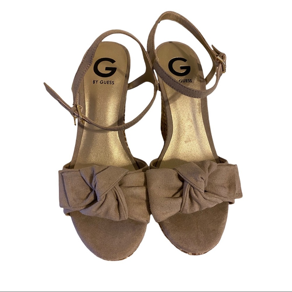 The Dalina sandal wedge from G by GUESS in tan and gold raffia.